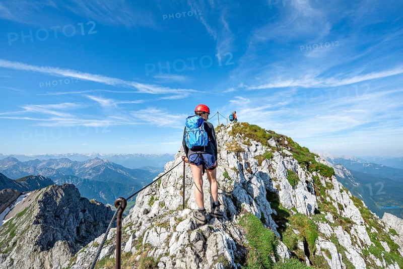 Mountaineer on a ridge on a secured via ferrata