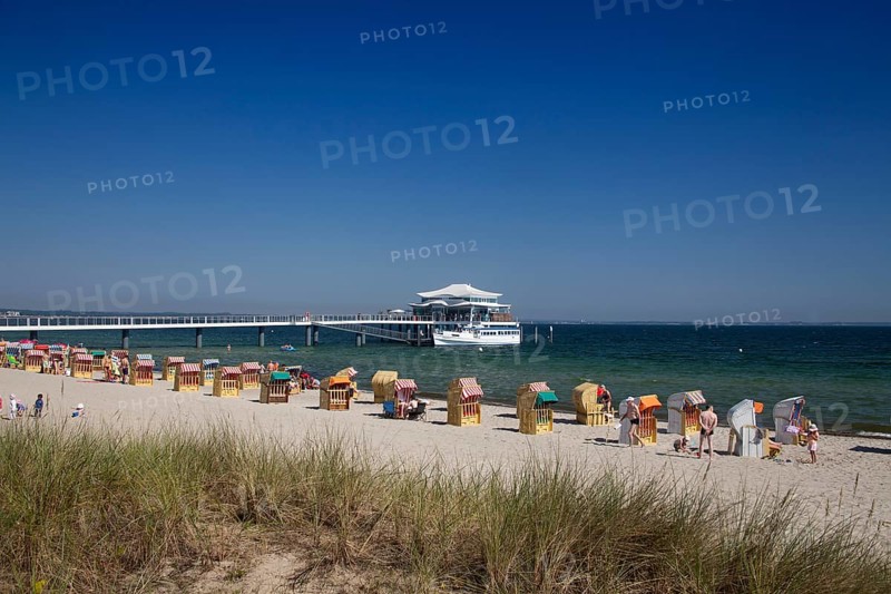 Beach chairs at Timmendorfer Strand with Seeschloesschenbruecke and Japanese teahouse