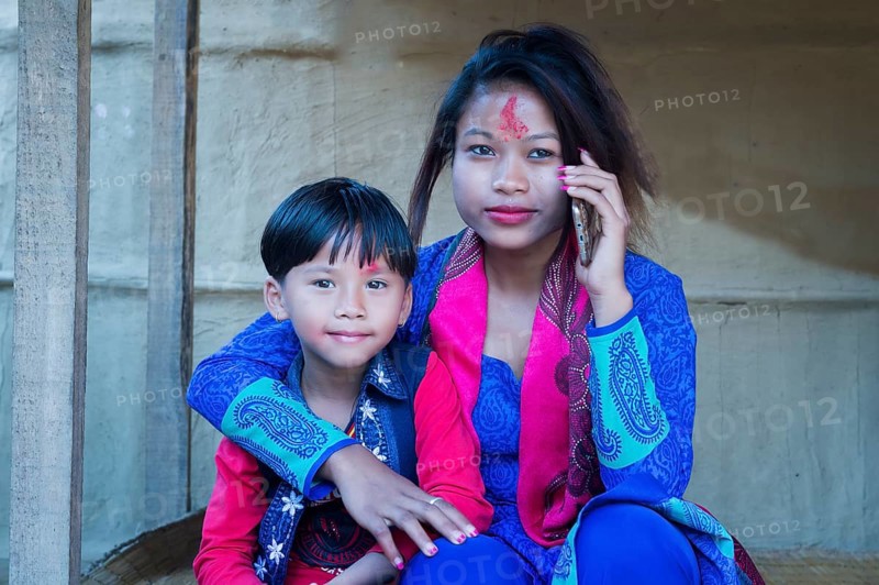 Nepalese woman with her son from the Tharu ethnic group