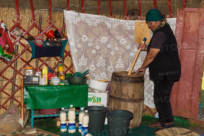 Kyrgyz woman mixing kumis during the fermentation process