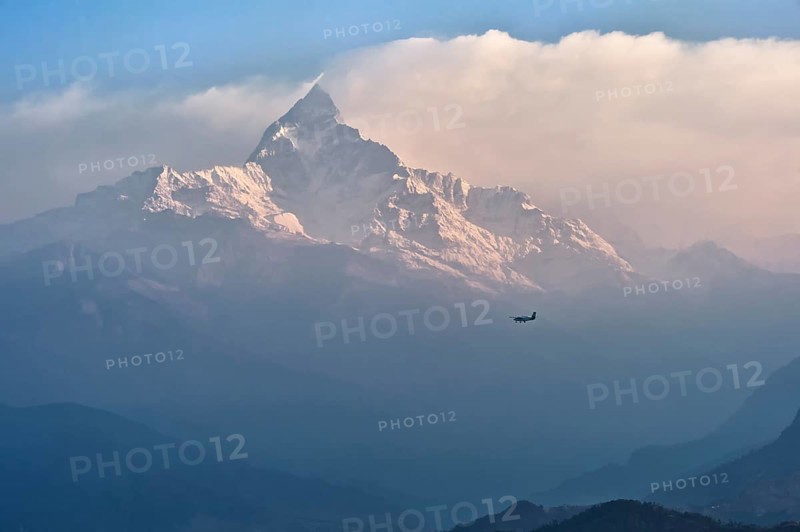 Small plane flies to sacred peak Machhapuchhare Fishtail Mountain