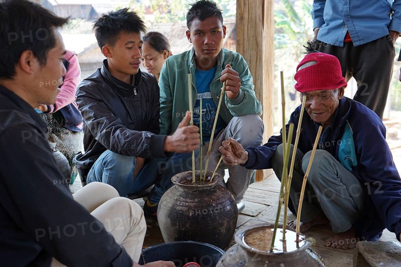 Members of the Khmu people drinking rice wine