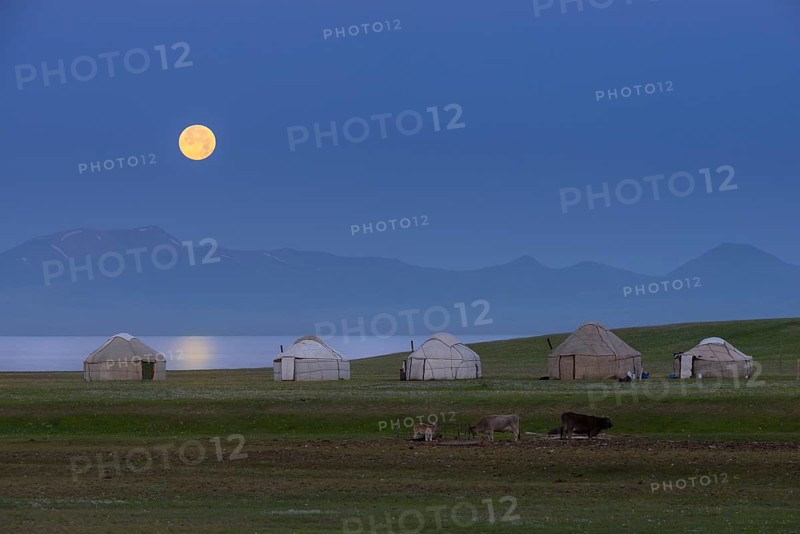 Moonrise over Song Kol Lake and nomadic yurts