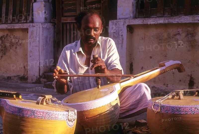 Man works at Veena instrument