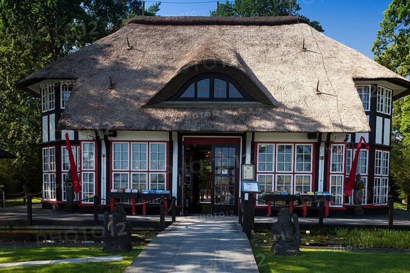 Thatched roof house Mikado Garden with Buddha rope