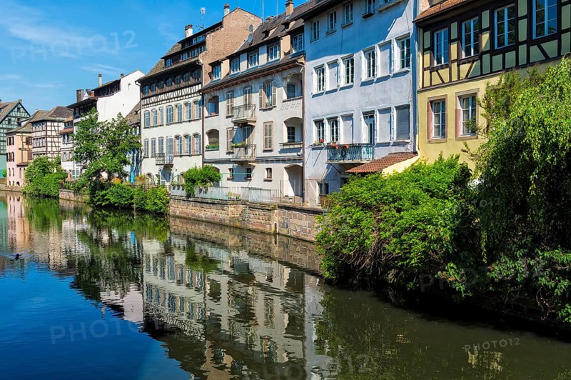 Half-timbered houses reflected in the ILL canal along the Quai de la Petite France