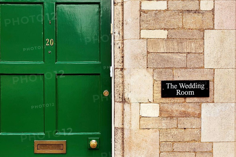 Facade with green door and sign Wedding Room