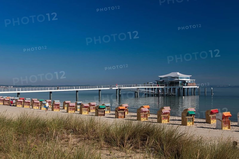 Beach chairs at Timmendorfer Strand with Seeschloesschenbruecke and Japanese teahouse