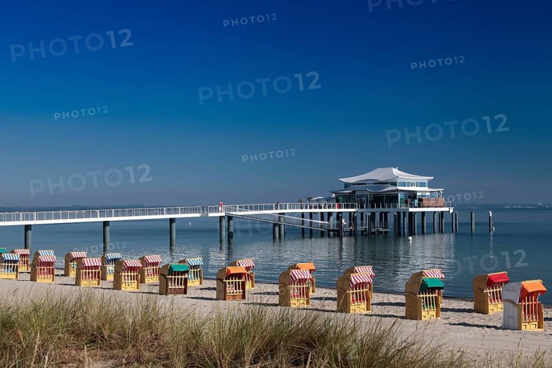 Beach chairs at Timmendorfer Strand with Seeschloesschenbruecke and Japanese teahouse