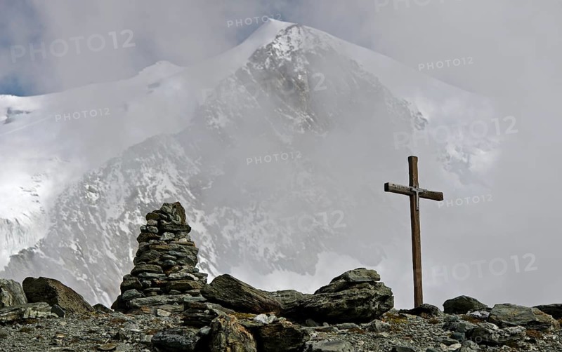 Summit cross and cairn in front of the Bishorn