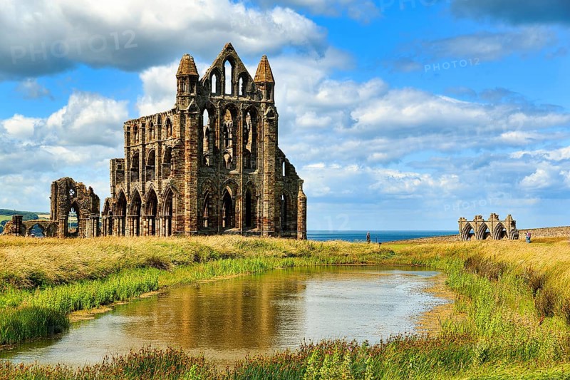 Ruin of the Gothic monastery Whitby Abbey with visitors