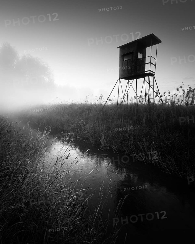 German floodplain landscape in Brandenburg with high seat on the Nuthe in black and white
