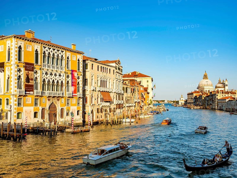 Gondola and boats next to Palazzo Franchetti Cavalli in the Grand Canal