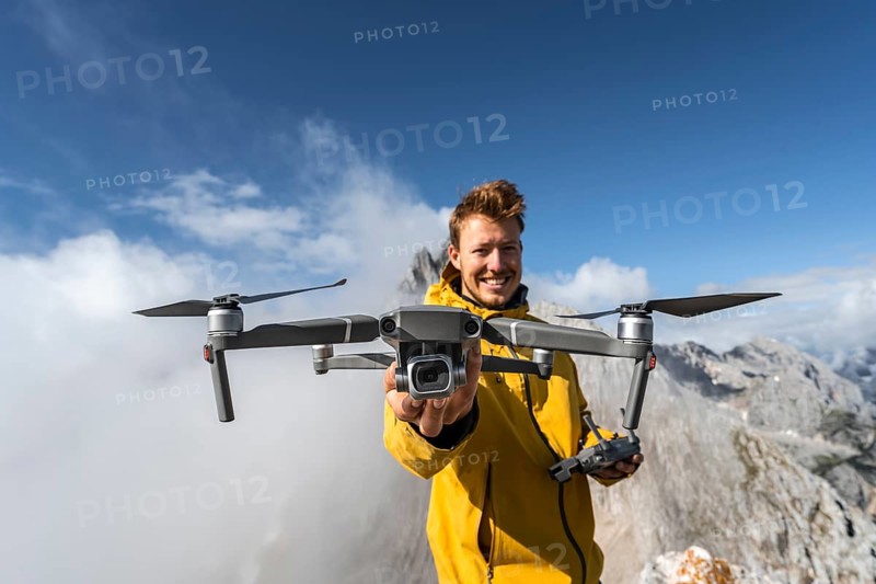Young man holding a drone with camera