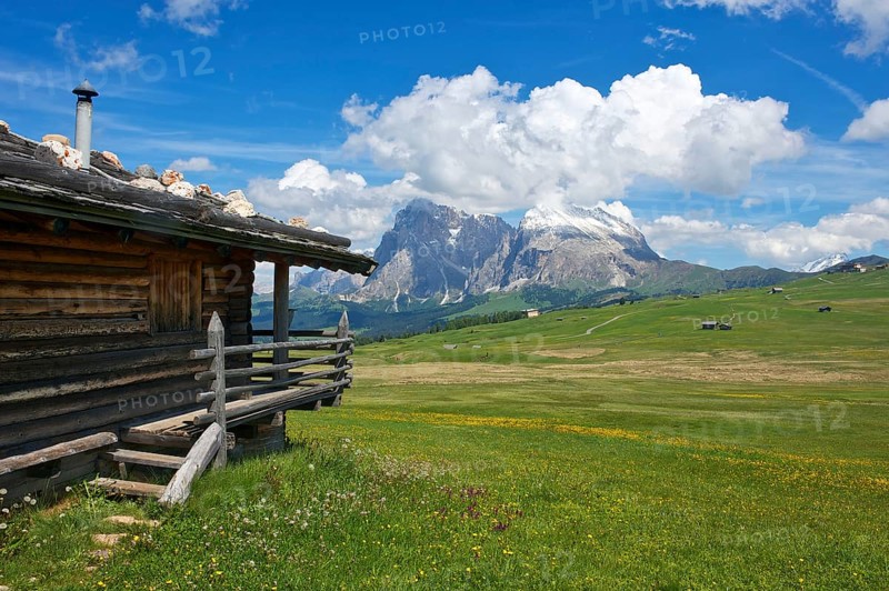 Alpine huts on the Alpe di Siusi with Sassolungo and Sassolungo