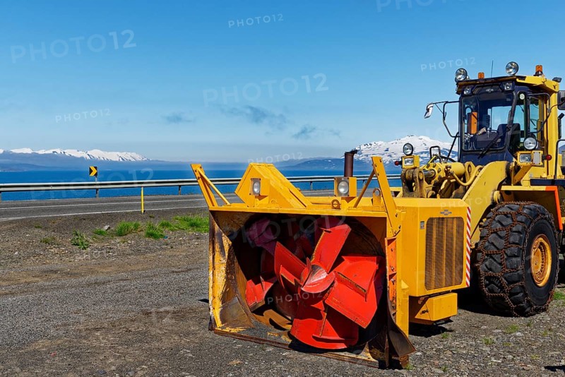Wheel loader with snowblower and snow chains