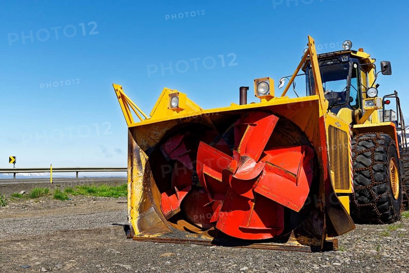 Wheel loader with snowblower and snow chains