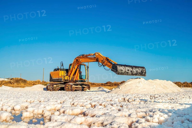 Excavator harvesting sea salt