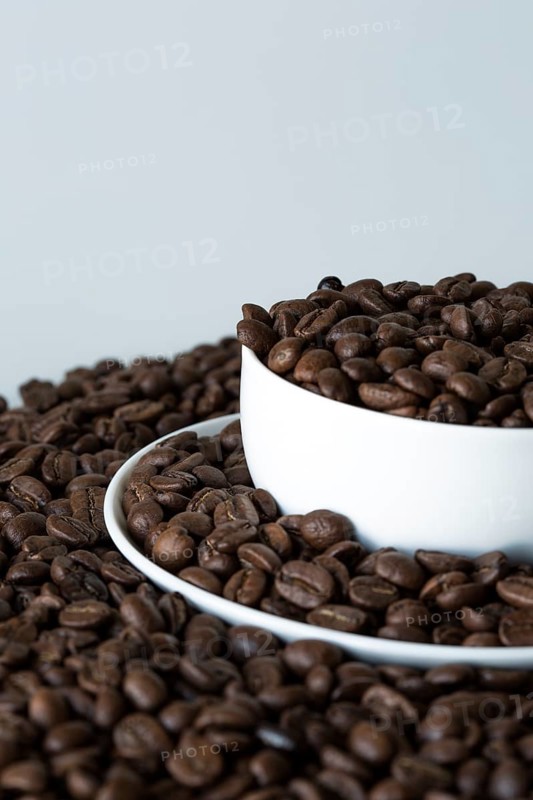 A cup of coffee on coffee beans