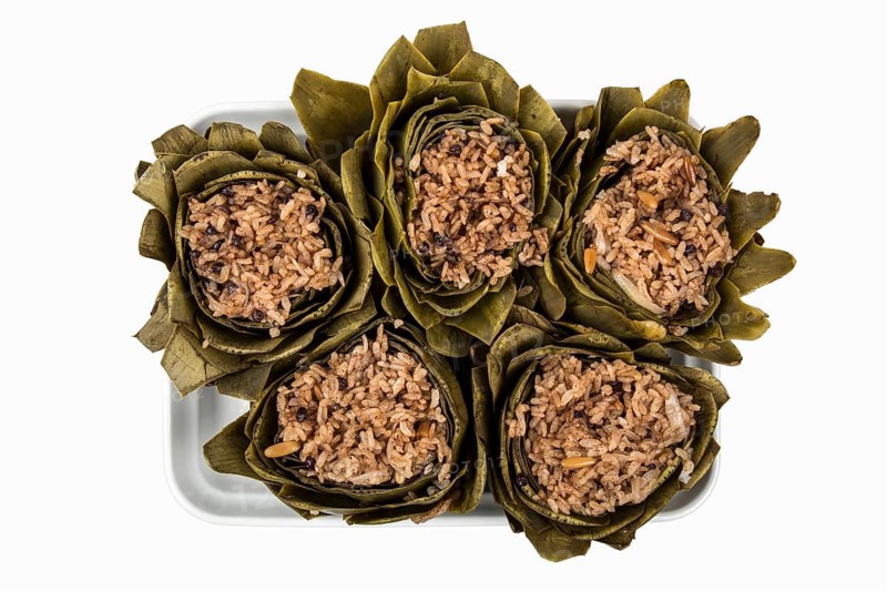 Plate with artichoke rice against a white background
