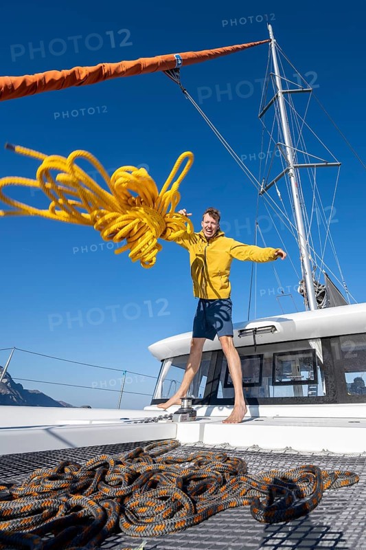 Sailor throws a yellow rope towards the camera