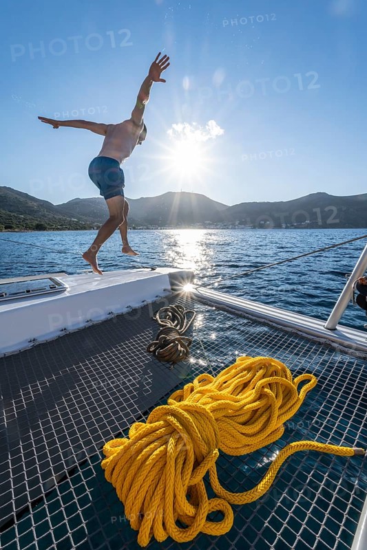 Young man jumps into the water