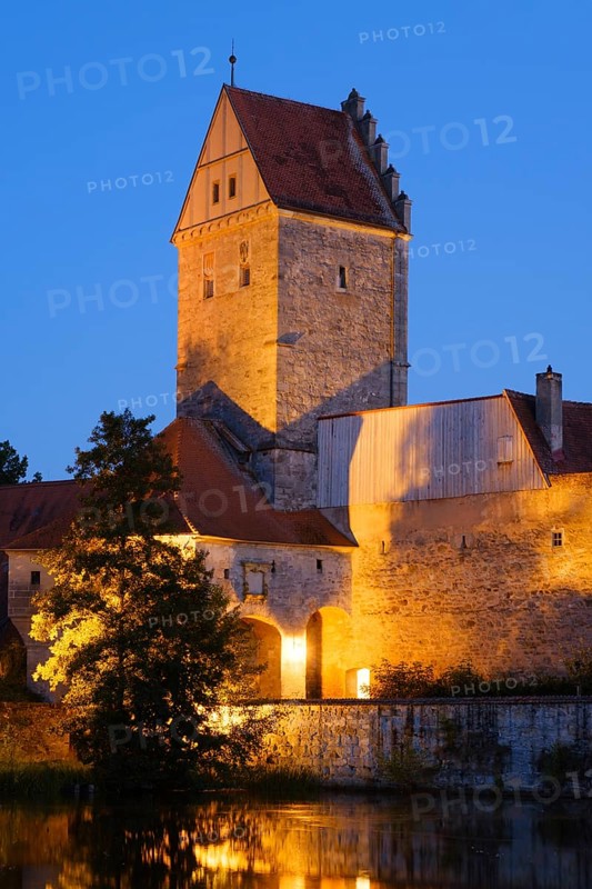 Illuminated Rothenburg Gate with city wall at the city pond
