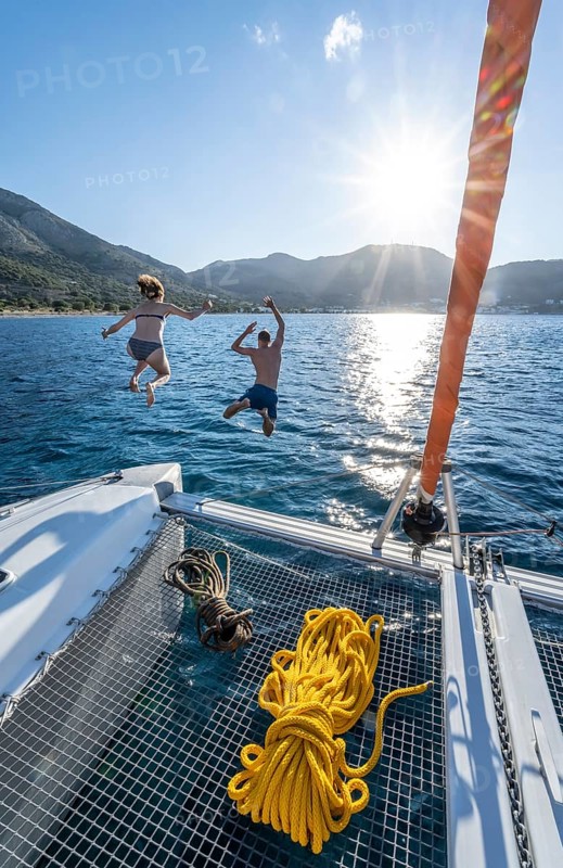Young woman and young man jumping into the water