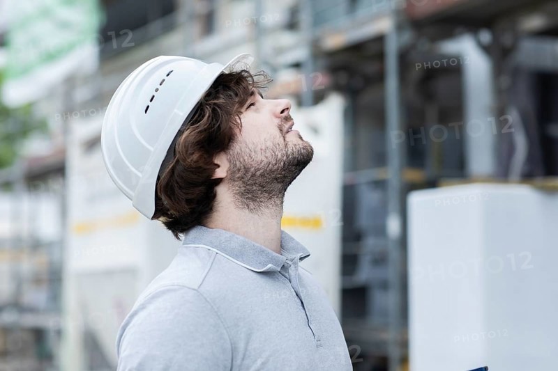 Technician with beard middle aged and working outside with polo shirt and helmet