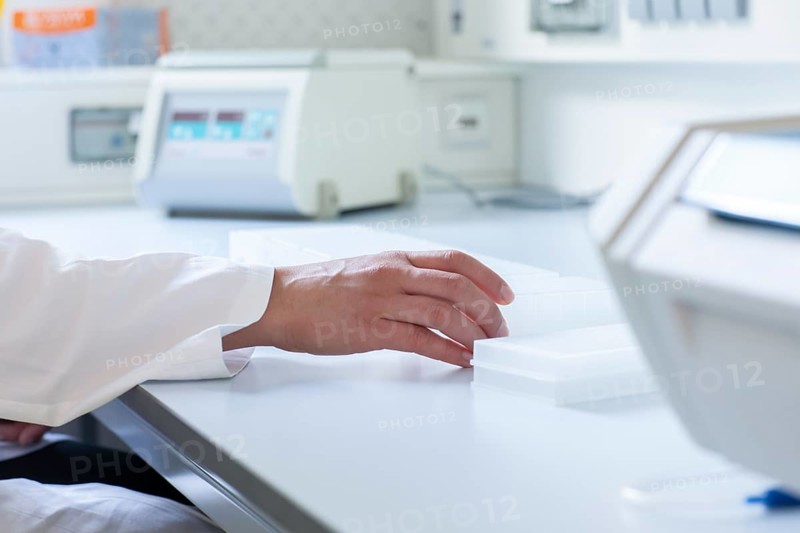 Multiple samples in the hand of a laboratory technician on the laboratory table in the Freiburg laboratory