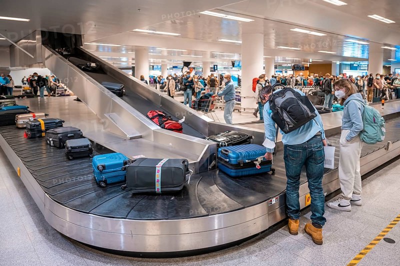 People waiting at baggage claim at an airport
