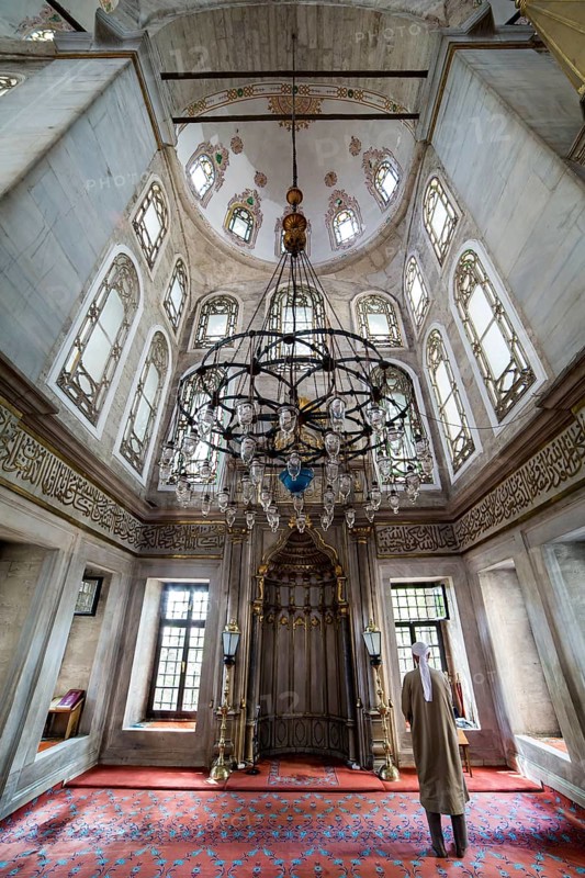 He performs the ritual prayers of Islam in Eyup Sultan