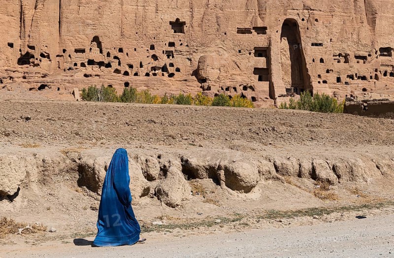 Woman in Burkha before the great buddhas in Bamyan