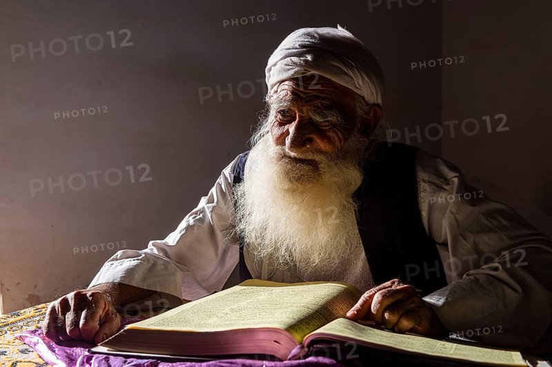 Sufi priest studying the holy Quran in the Shrine of Mawlana Abdur Rahman Jami