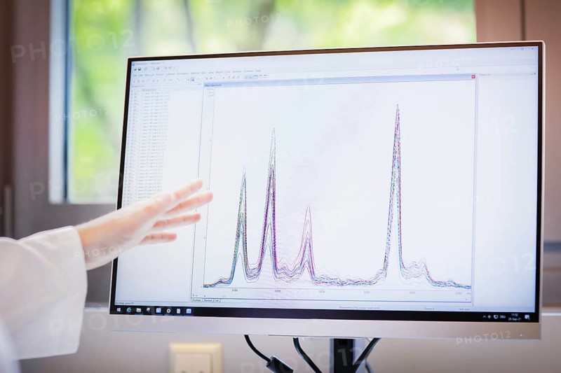 Screen with evaluation diagram and hand pointing to monitor