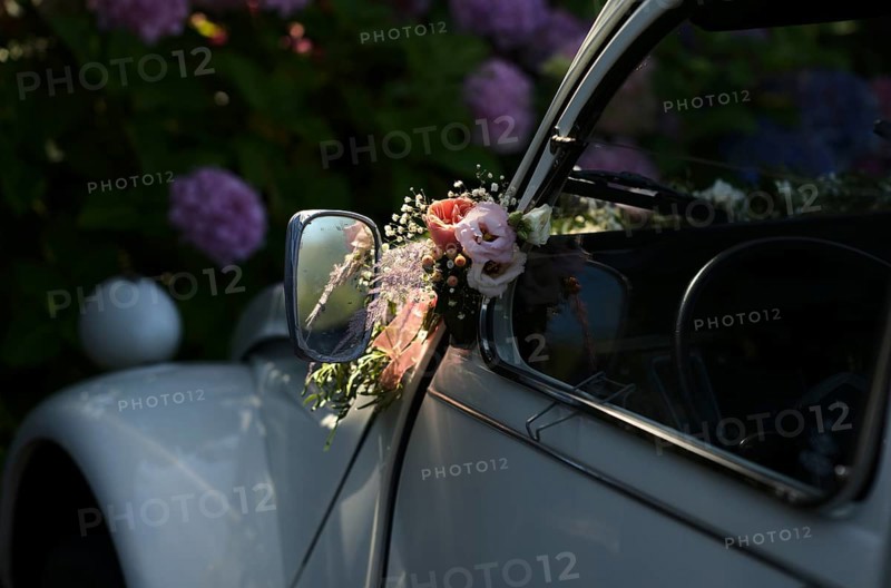 Wedding decoration on the wing mirror of a car