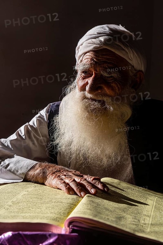 Sufi priest studying the holy Quran in the Shrine of Mawlana Abdur Rahman Jami