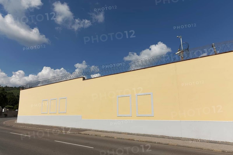 Prison wall with painted window frames