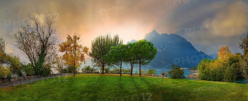 Breathtaking sunset on Lake Garda with hiker
