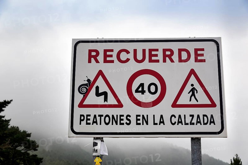 Sign with various traffic signs warning pedestrians on the road
