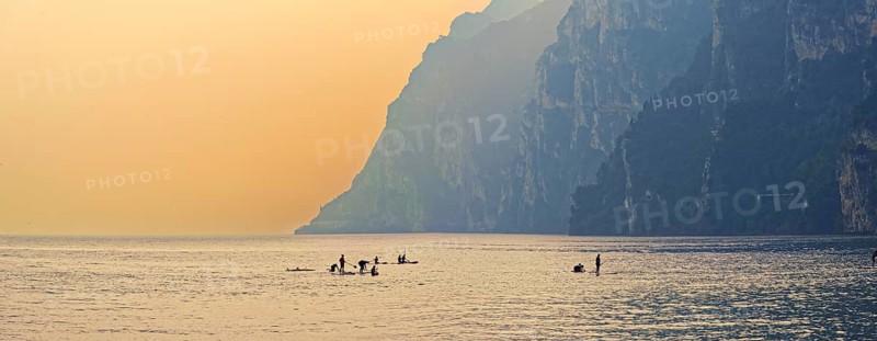 Standing board athlete at sunset
