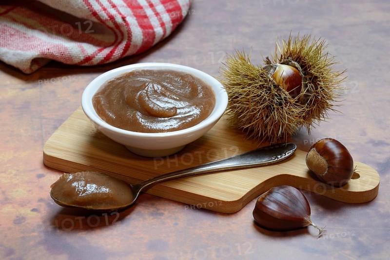Chestnut cream in bowl on wooden board