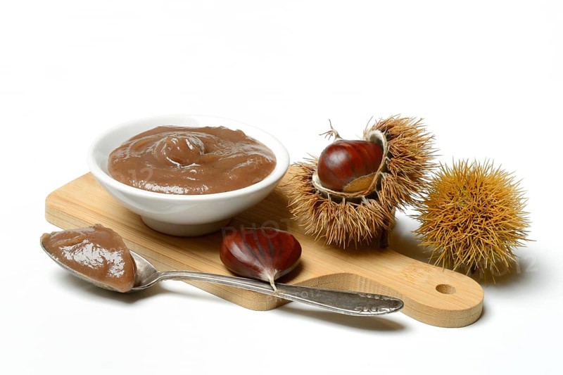Chestnut cream in bowl on wooden board