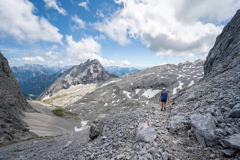 Hiker crossing a scree field
