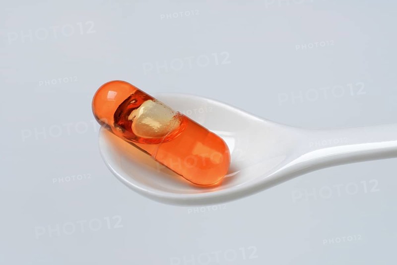 Capsule with omega-3 fatty acids in spoon