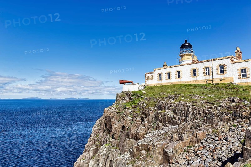 Lighthouse with foghorn on cliff