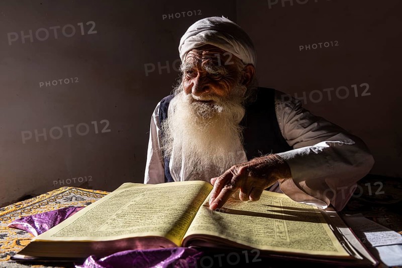 Sufi priest studying the holy Quran in the Shrine of Mawlana Abdur Rahman Jami