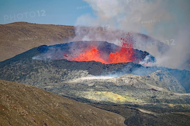 Lava fountains bubbling in a volcanic crater