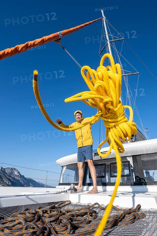 Sailor throws a yellow rope towards the camera