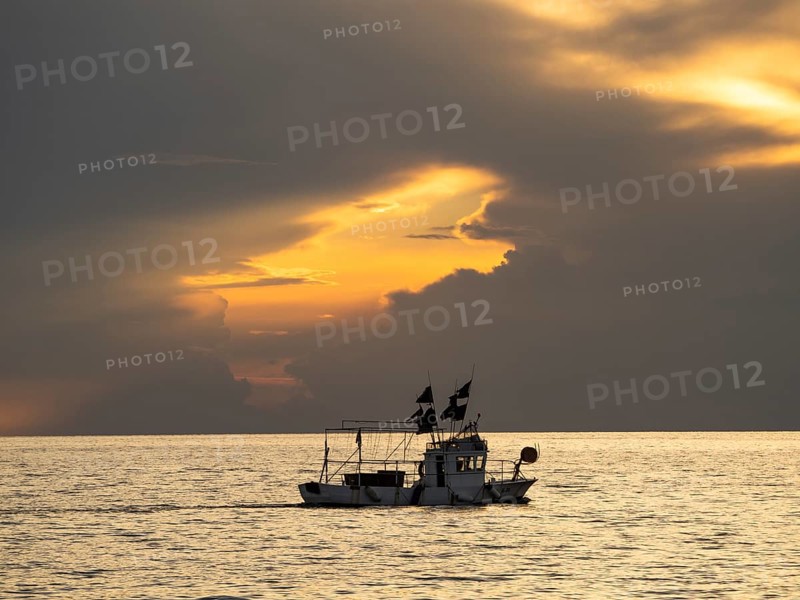 Fishing boat in front of dark clouds